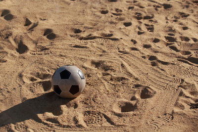 High angle view of soccer ball on sand