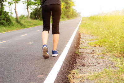 Low section of woman on road