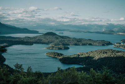 Scenic view of sea and mountains against sky