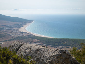 High angle view of land and sea against sky