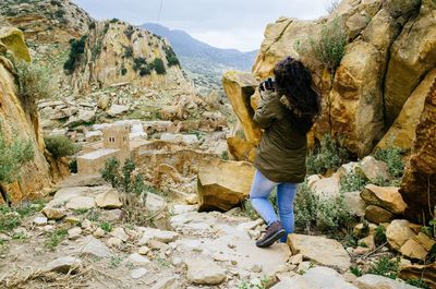 Rear view of man on rock