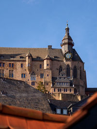 Low angle view of buildings against clear blue sky