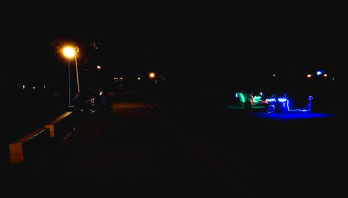 Illuminated city street at night