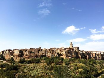 Old buildings on mountain against sky