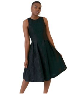 Portrait of young woman standing against white background