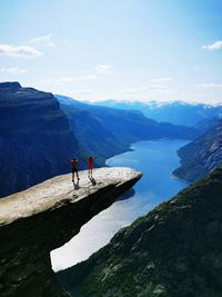 People on mountain against sky