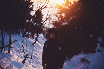 Portrait of man standing in snow