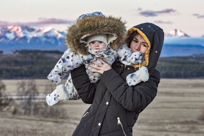 Portrait of woman with child during winter