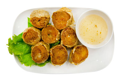 Close-up of food in plate on white background