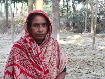 Portrait of young woman standing outdoors