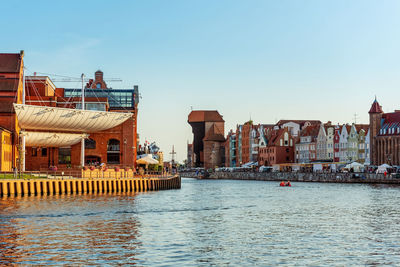 Buildings in city against clear sky