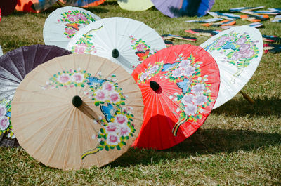 Close-up of multi colored umbrellas on field