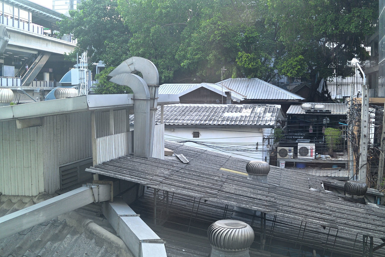 HIGH ANGLE VIEW OF BUILDINGS BY TREES