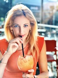 Portrait of a woman drinking from a restaurant