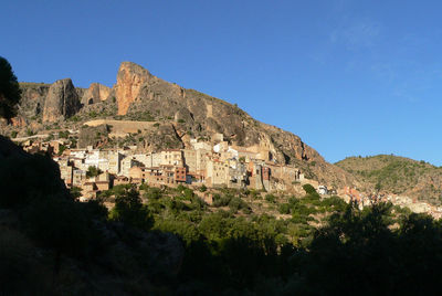 Scenic view of mountains against clear blue sky