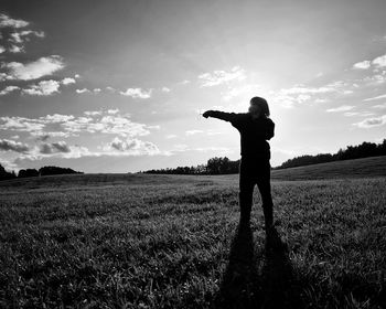 Full length of man standing on field against sky