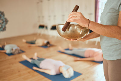 Midsection of woman holding glass