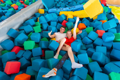 High angle view of people in multi colored toys