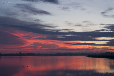 Reflection of cloudy sky in river at dusk