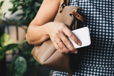 Midsection of woman with purse