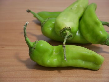 Close-up of green chili peppers on table