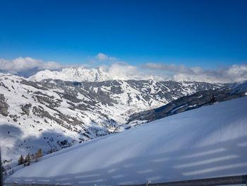 Scenic view of snowcapped mountains against blue sky