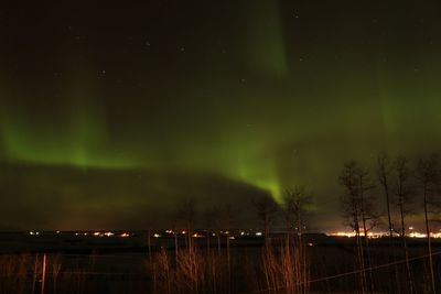 Scenic view of landscape against sky at night