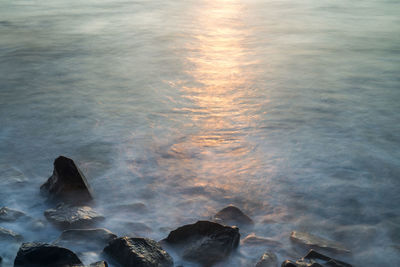 High angle view of rocks on beach against sky