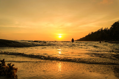 Scenic view of beach against sky during sunset