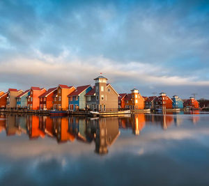 Reflection of buildings in water against sky