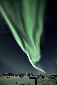 Low angle view of snow against sky at night