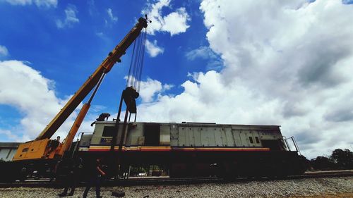 Low angle view of man working at railroad station