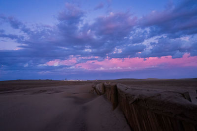 Scenic view of desert against sky during sunset