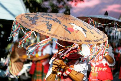 Woman holding chinese umbrella during festival