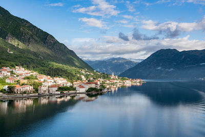 Scenic view of lake by mountains against sky