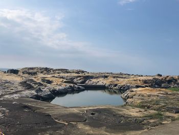 Rock formations on land against sky