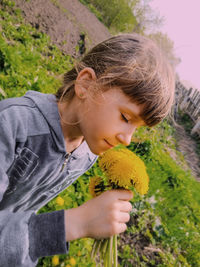 Close-up of girl smelling flowers