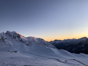 Scenic view of snowcapped mountains against clear sky during winter