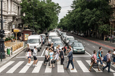 People crossing road in city