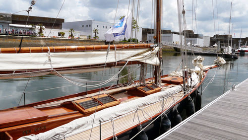 Boats moored on sea against sky