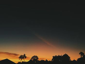 Low angle view of silhouette trees against sky during sunset