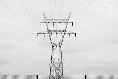 Low angle view of electricity pylon against sky