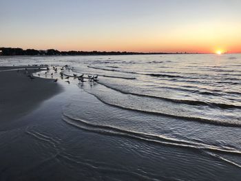 Scenic view of sea against clear sky during sunset