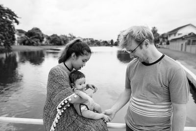 Rear view of mother and daughter in water