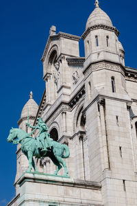 Low angle view of statue in montmatre against sky