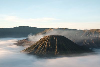 View of volcanic mountain against cloudy sky