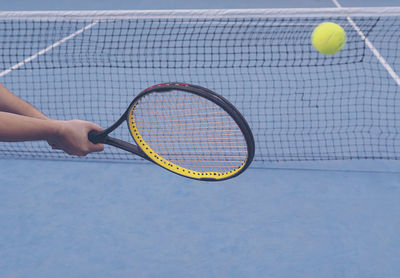 Cropped hands playing tennis