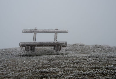 Frozen bench on grass