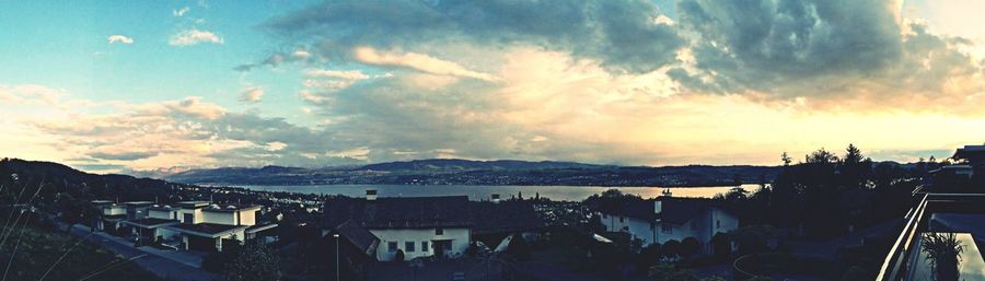 Scenic view of mountains against cloudy sky at sunset