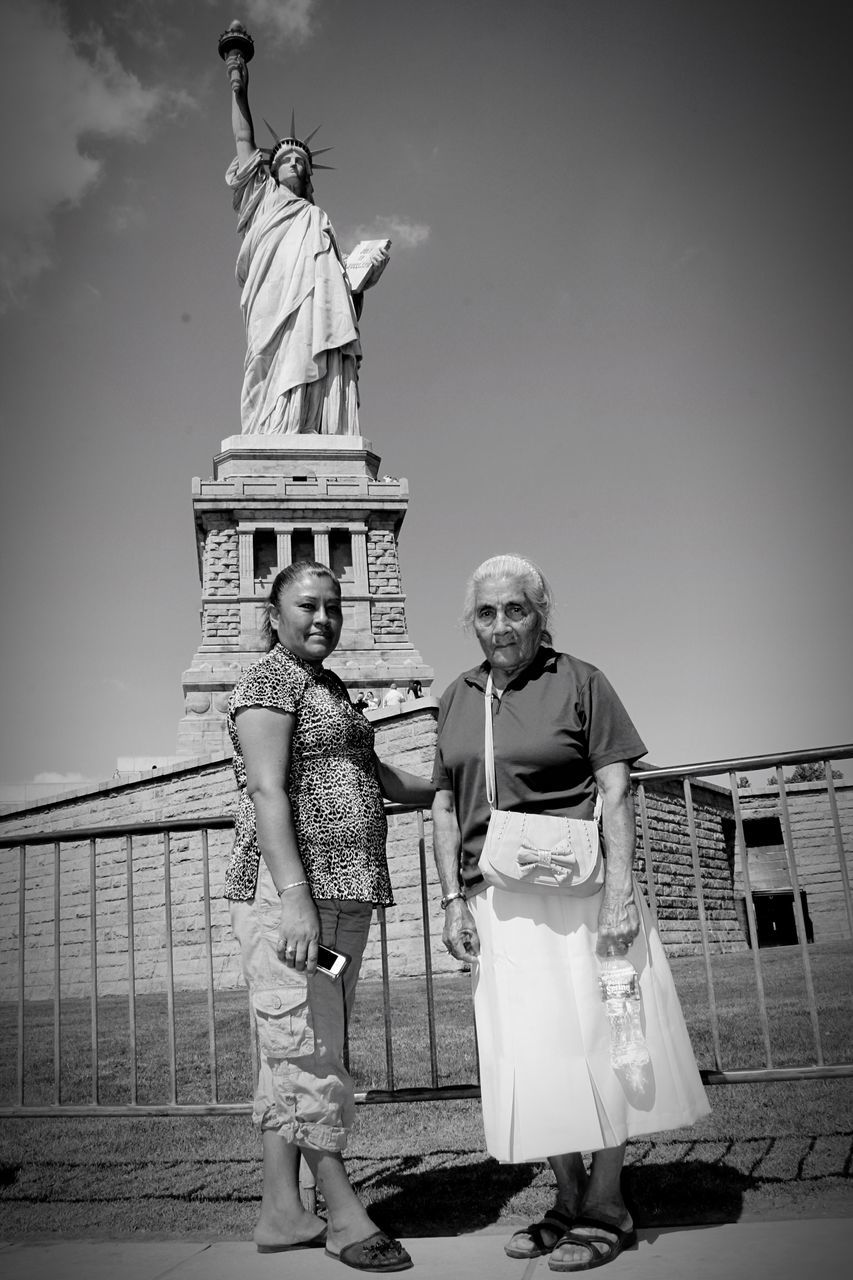 TWO PEOPLE STANDING ON WALL